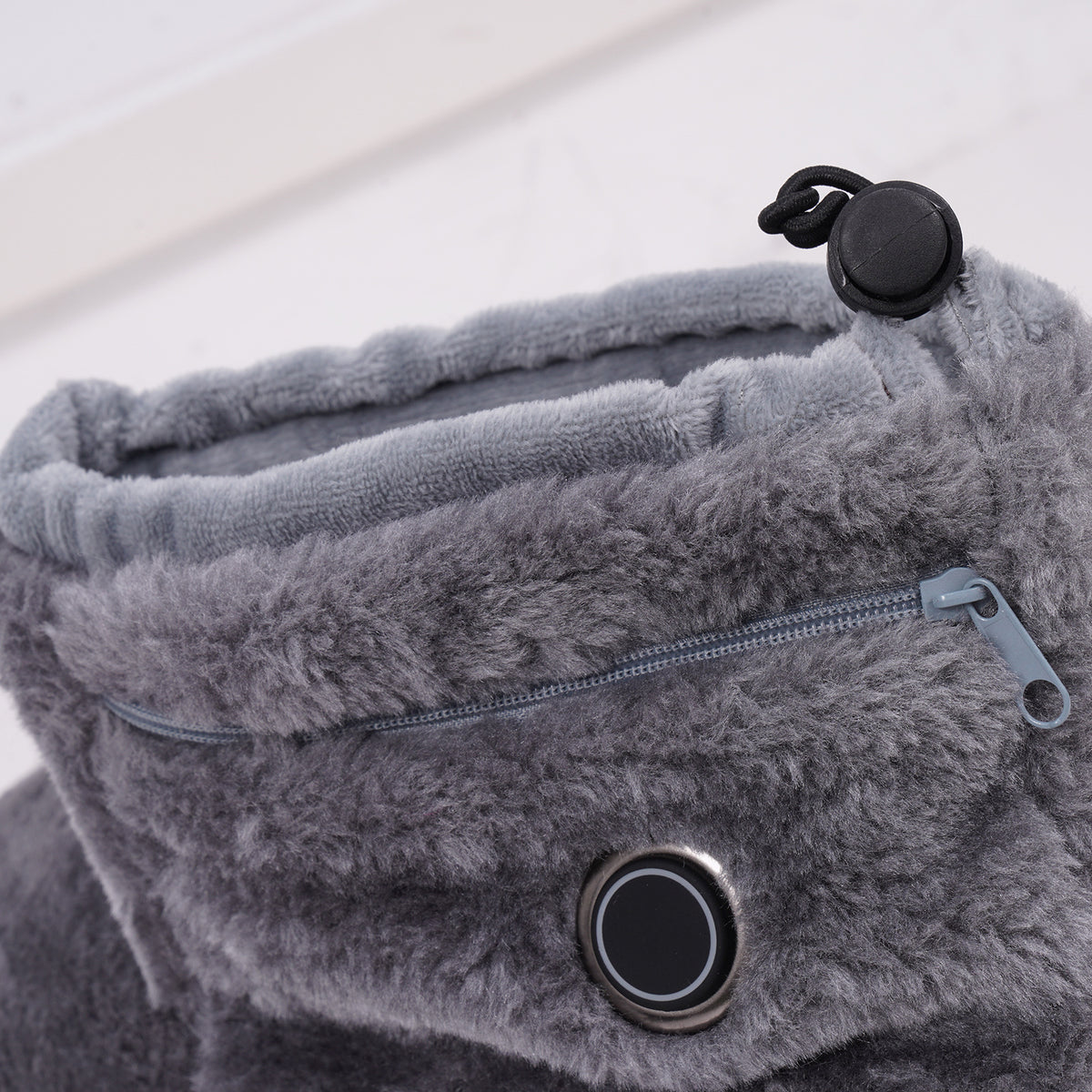 Soft grey fabric, control button, zipper and adjustable cuff